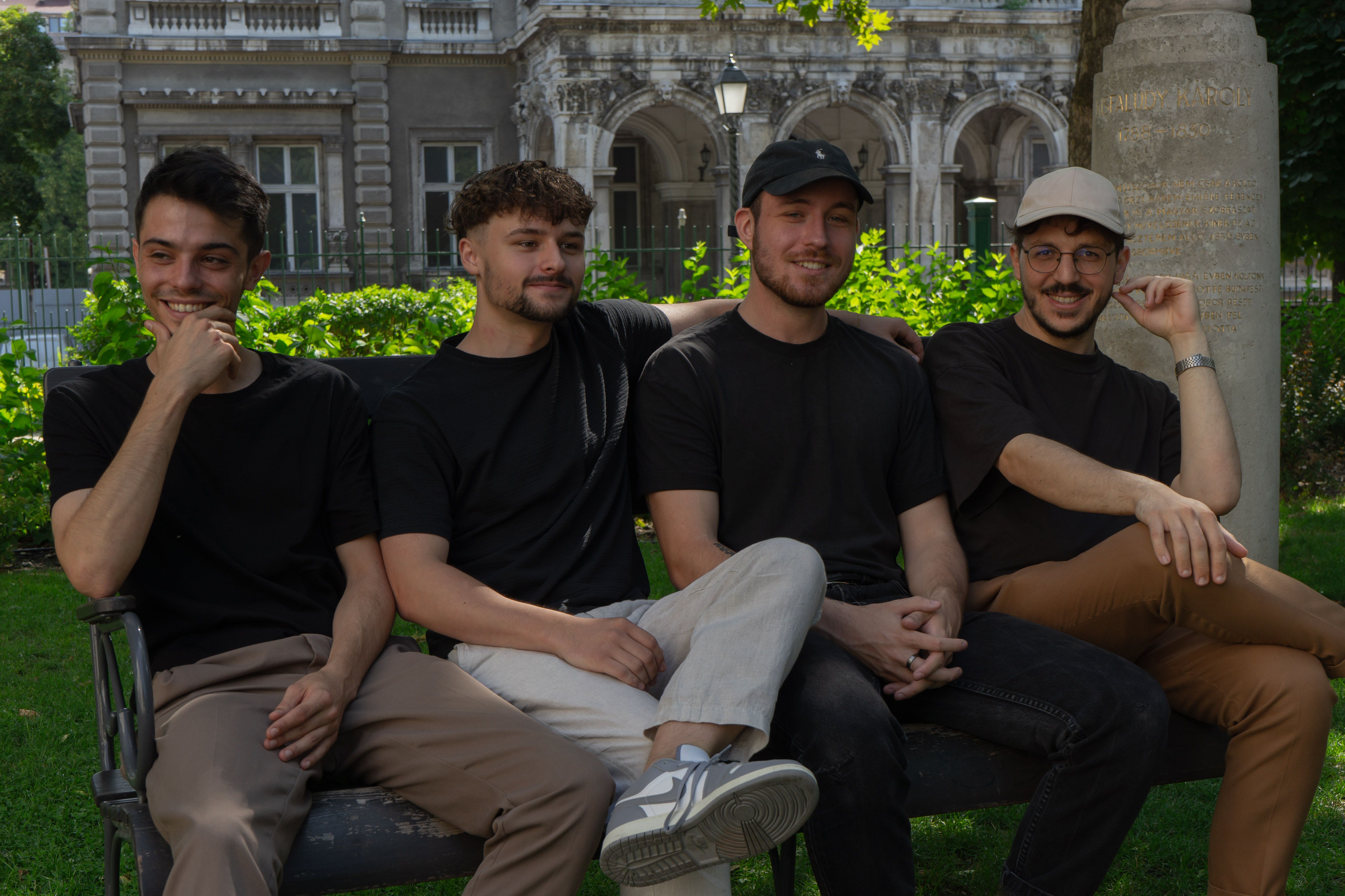 Four of the Once Advertisements employees, Kristof Menesi, Krisztian Mezei, Matyas Laneury, and Gergo Mezes sitting on a bench in the ‘Museum Garden’ in Hungary.